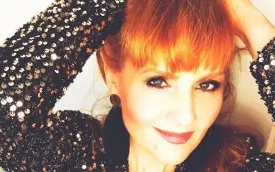 Alleksandra Kovač pozira našminkana Aleksandra Kovač poziira našminkana sa crvenim karminom i velikim ljubičastiim minđušama u obliku cveta