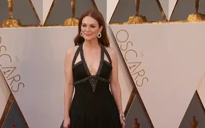 Julianne Moore na crvenom tepihu Julianne Moore u crnoj haljini sa osmehom na licu