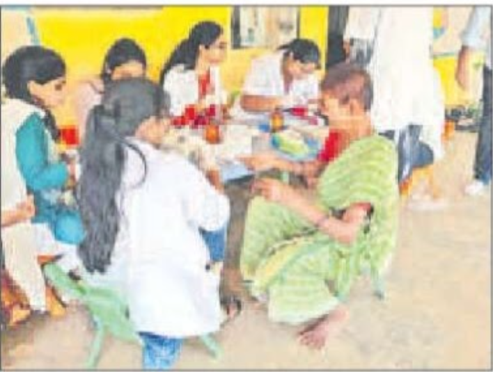 Pharmacy students conducting blood group tests for villagers in Musi again village