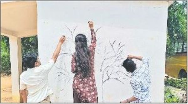 Students painting on the walls of MPP school