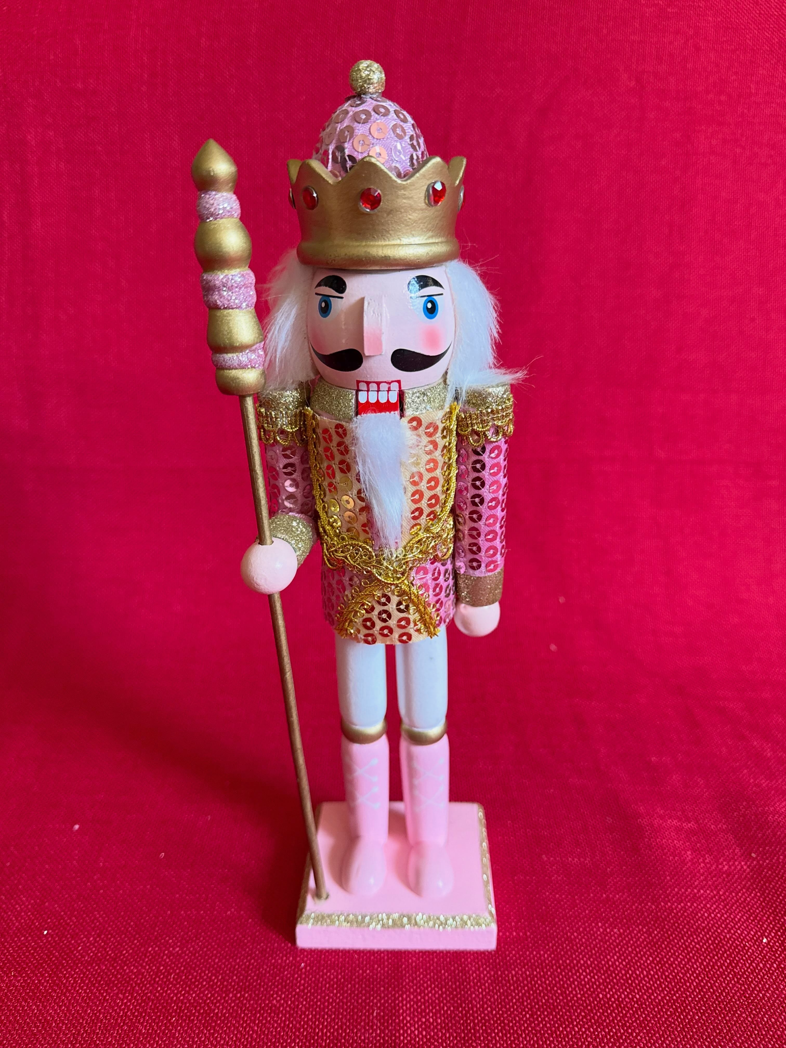 Adorno navideño de cascanueces dorado y rosado