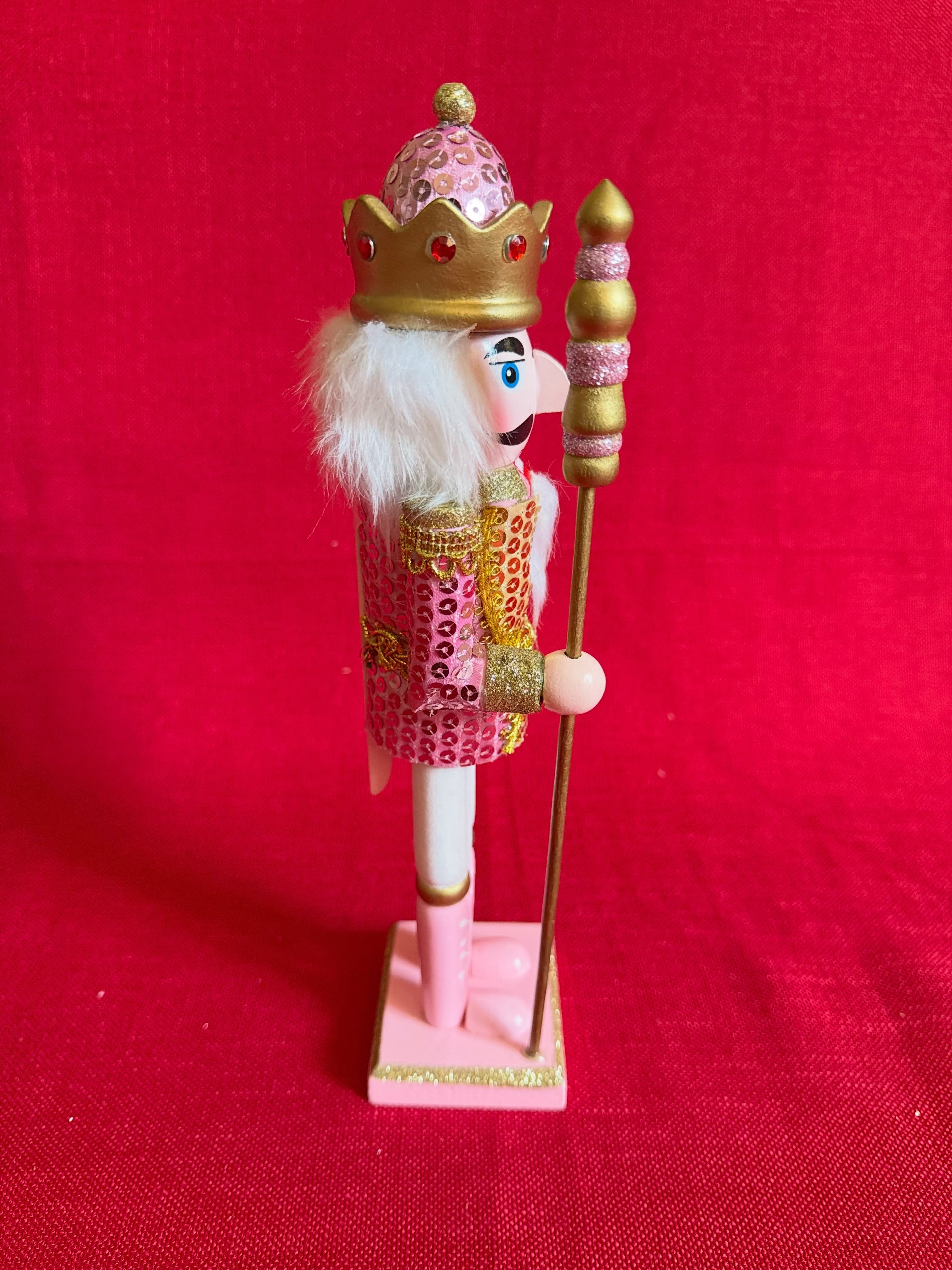 Adorno navideño de cascanueces dorado y rosado