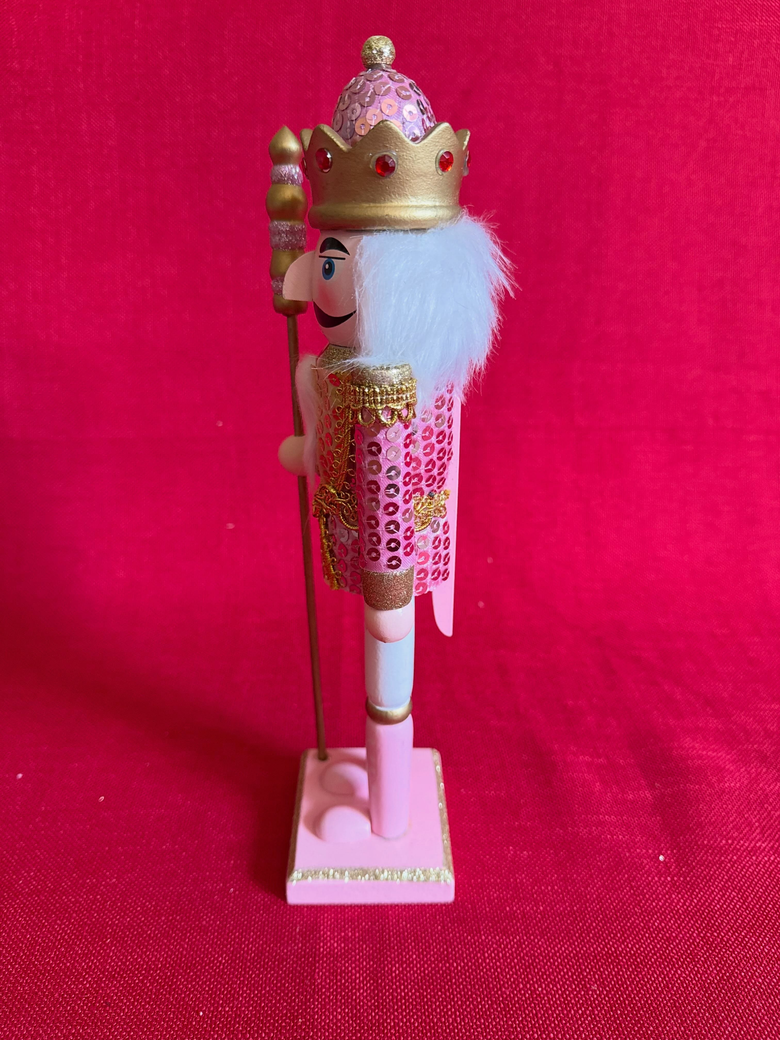 Adorno navideño de cascanueces dorado y rosado