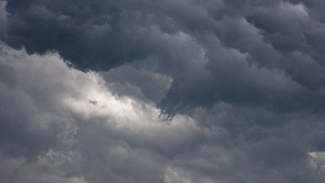 A captivating image of dense, dark clouds in a dramatic overcast sky, hinting at a storm.