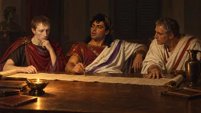 An illustration of a shuttered Roman room lit by one low lamp: three men sit along the far side of a long table with an unrolled list between them, one passing a stylus, one reading intently, one with a hand flat on the table.