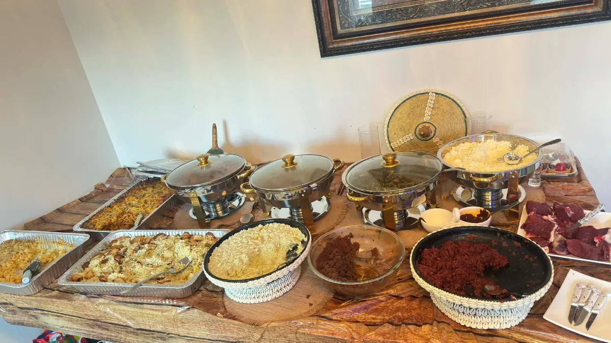Buffet table loaded with aromatic dishes, including rice, meats, and flavorful sides, all displayed elegantly.