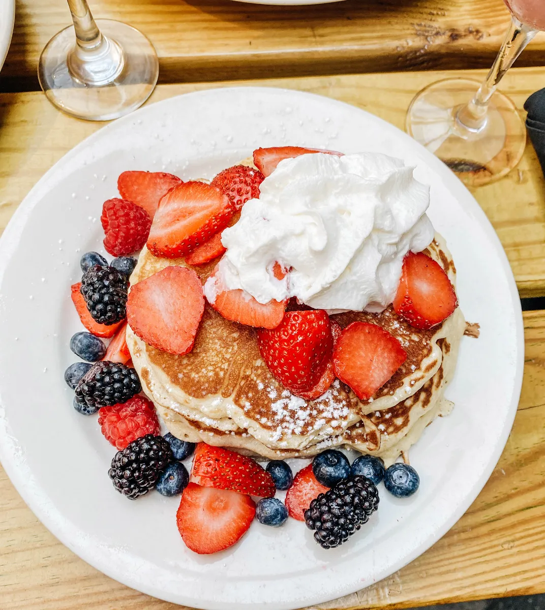 The Best Buttermilk Pancakes topped with fresh berries and whipped cream at Loreley Beer Garden