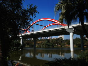A red and white bridge over a body of water