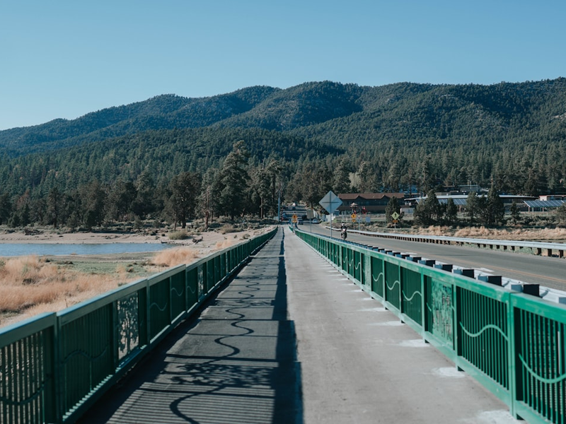 green and brown bridge near mountain during daytime