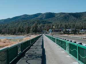 green and brown bridge near mountain during daytime