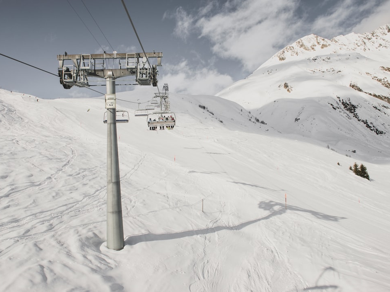 gray steel cable car post under cloudy sky during snow season