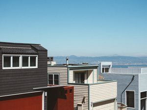 a row of houses with a mountain in the background