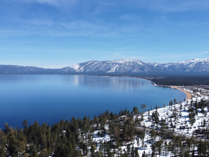 a large body of water surrounded by snow covered mountains