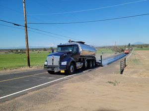 chip sealing a road.