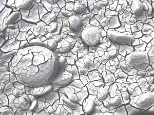 Dried and cracked mud/sand on a tidal riverbank. The low rainfall has lowered the river level. 