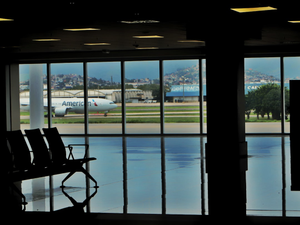 An airport terminal with an airplane outside.