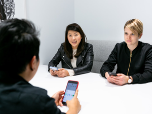 Three people in a meeting discussion app development. Mapbox Uncharted ERG (mapbox.com/diversity-inclusion) created these images to encourage and enable everyone in tech to represent LGBTQIA+ people at work, including collaboration and teamwork, leadership, design, engineering, and mobile development. These photos are free for anyone to use, as long as the use contains attribution to Mapbox. For more information see bit.ly/QueerTechPhotosAnnounce. For the full collection visit https://bit.ly/3chojW5