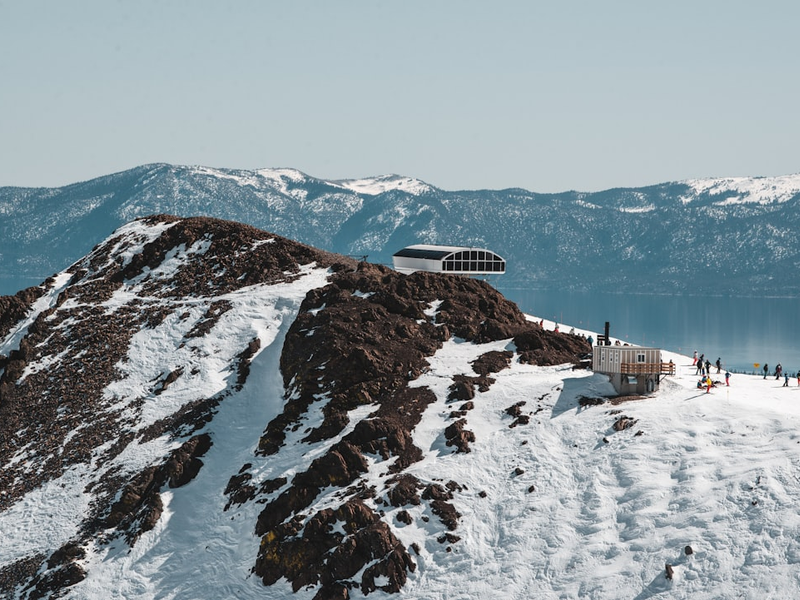 white and black building on snow covered mountain during daytime