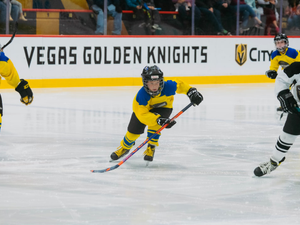 a group of young men playing a game of ice hockey
