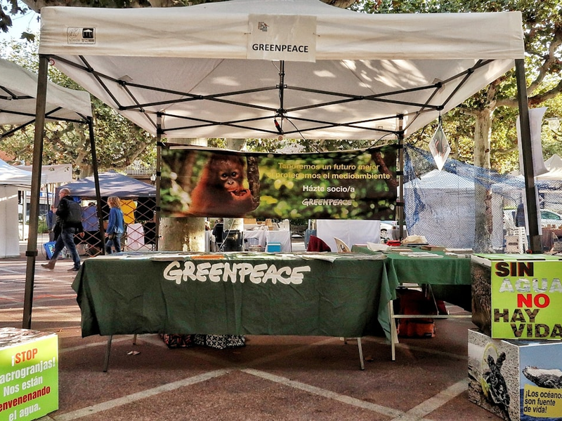 Greenpeace booth with environmental awareness signs