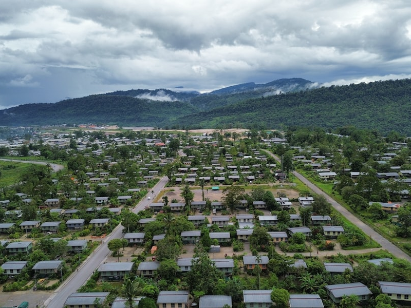 An aerial view of a small town with mountains in the background