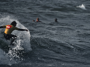 a man riding a wave on top of a surfboard