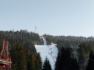 A ski lift going down a snowy mountain