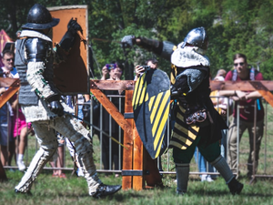 two people in armor holding swords