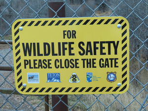 Wildlife Safety: Please Close the Gate sign