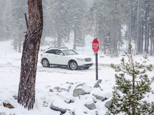 white sedan on snow covered road during daytime