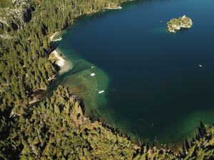 an aerial view of a lake surrounded by trees