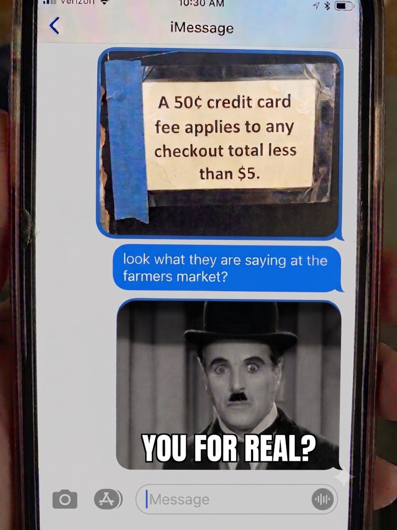 A text message showing a photo of a taped sign reading