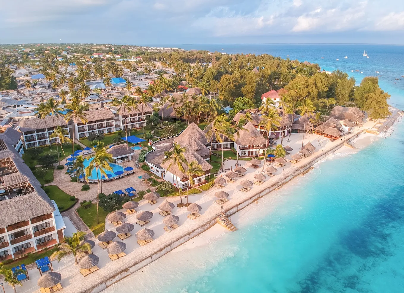 Aerial view of the beachfront, turquoise waters, and resort pools at Nungwi Beach Resort in Zanzibar.