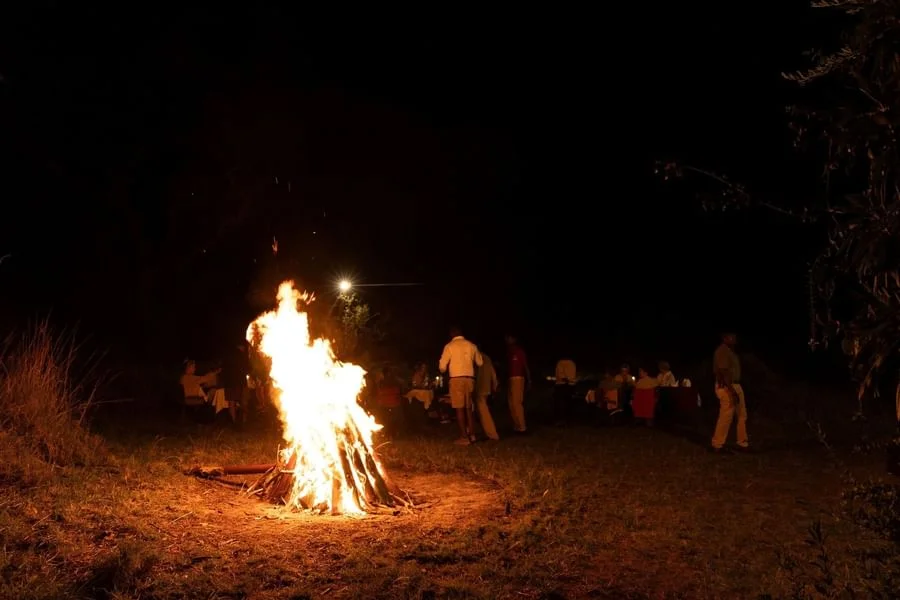 Roaring outdoor campfire blazing at night during a evening gathering at Ngorongoro Serena Safari Lodge.