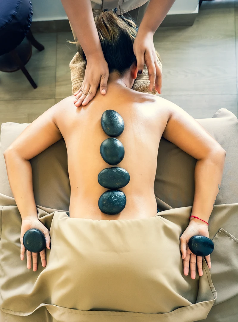 Relaxing hot stone massage therapy session at the resort spa in Zanzibar.