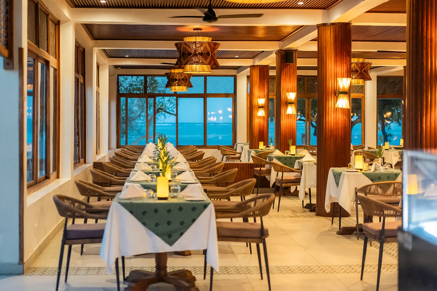 Elegantly set indoor restaurant dining area overlooking the ocean in Zanzibar