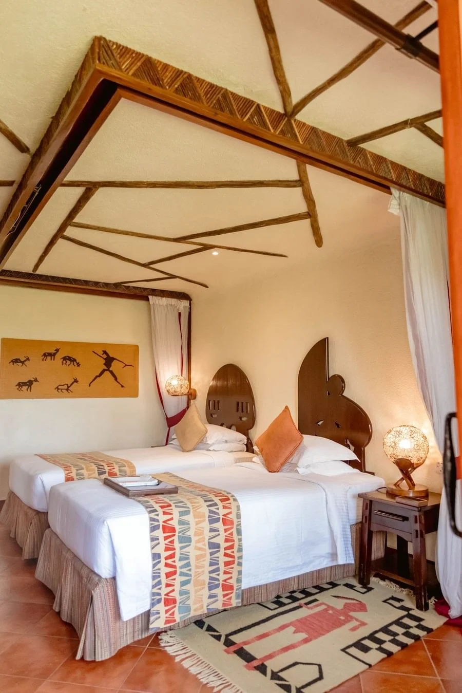 Twin guest room at Serengeti Serena Safari Lodge with African-inspired decor, two beds and warm safari-style interiors.