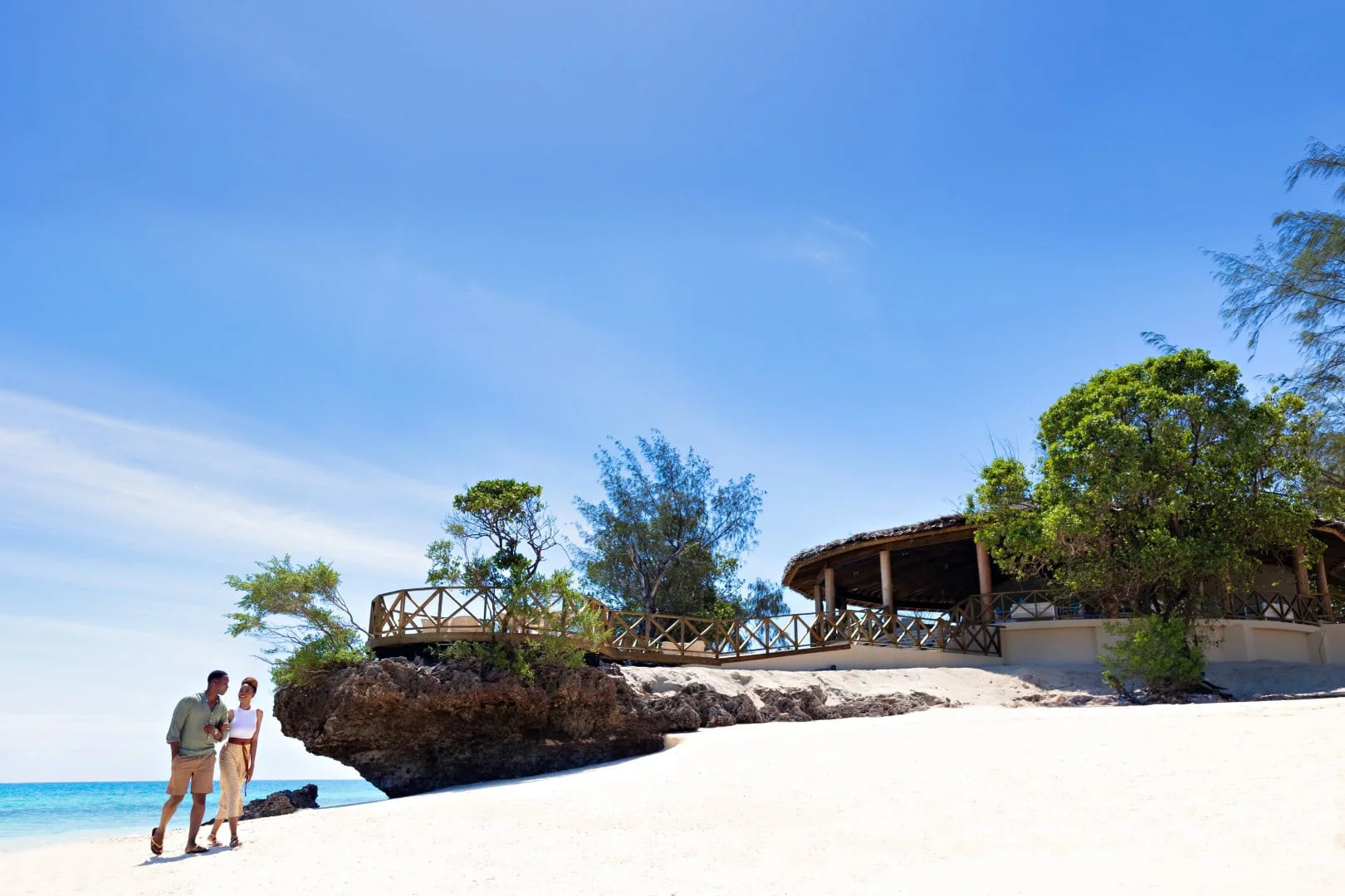 Traditional fishing boats resting on a coastal sand beach along the ocean.