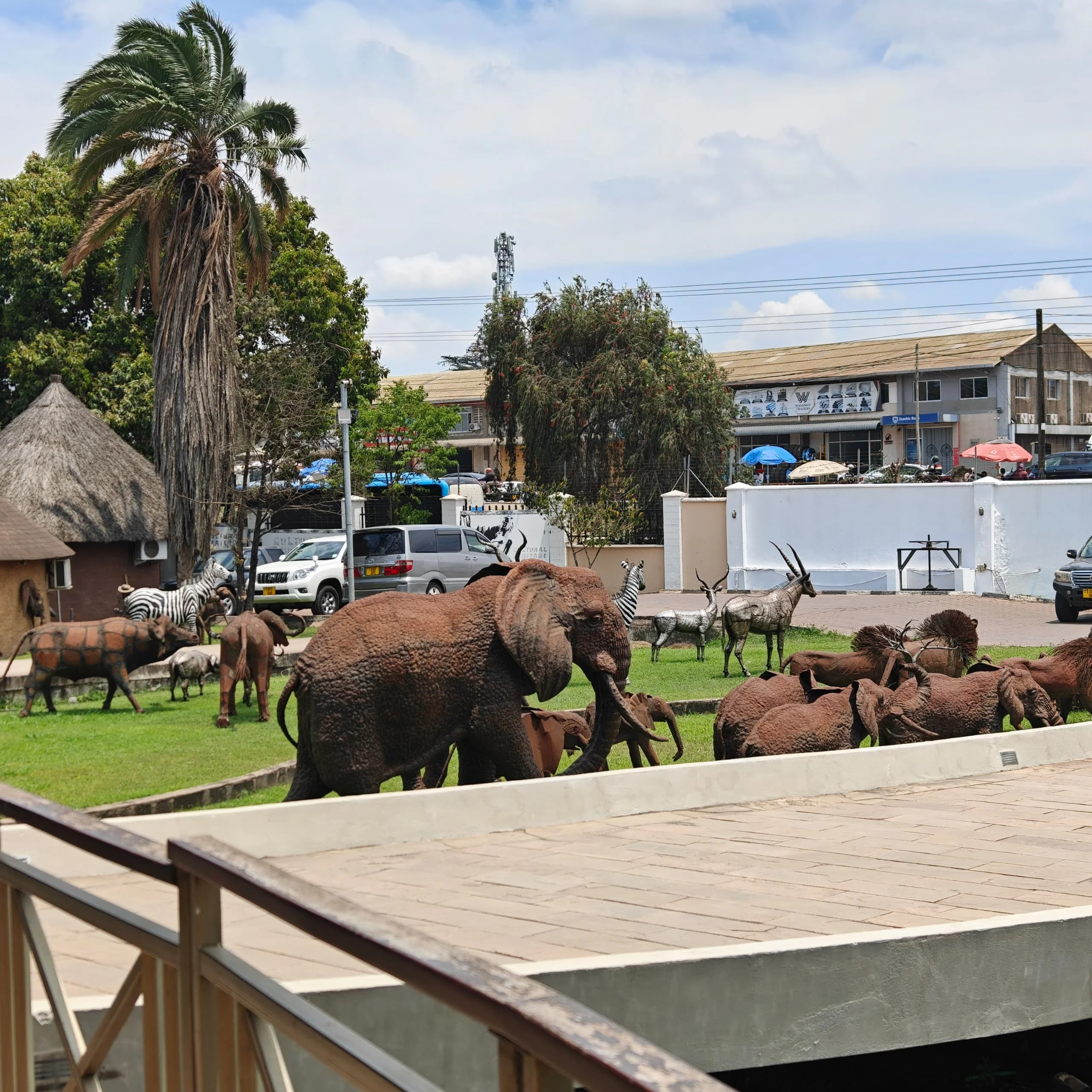 Outdoor courtyard display at Cultural Heritage Centre Arusha featuring large animal sculptures including elephants.