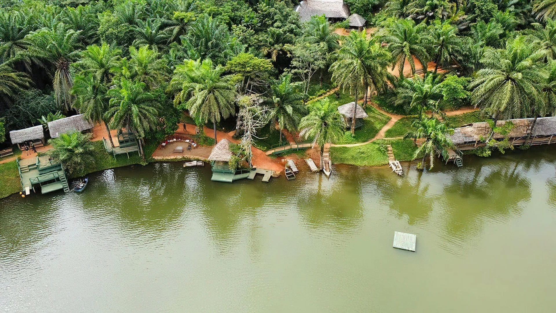 Stunning aerial drone view of a tranquil lake surrounded by dense green forest