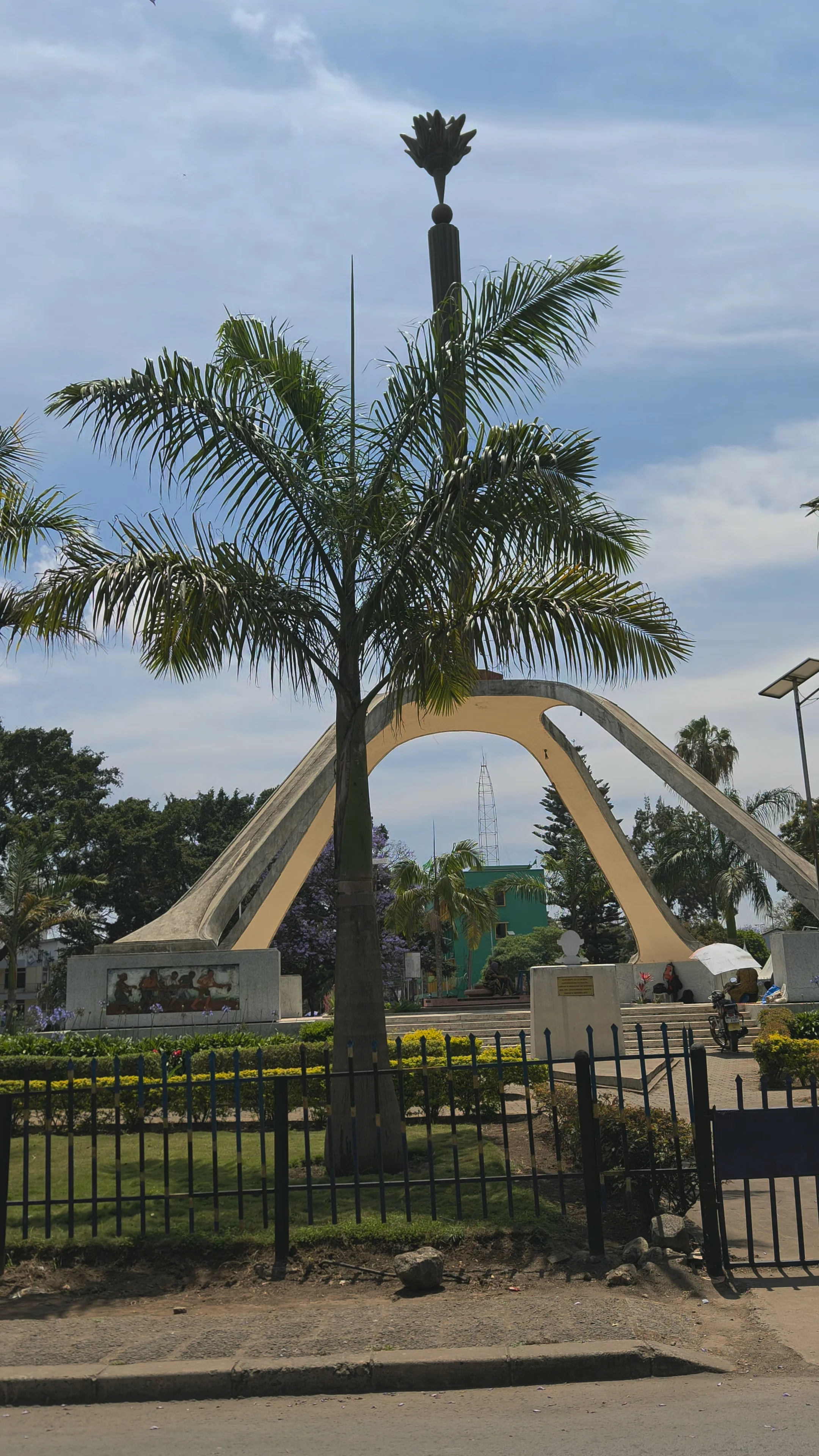 Landmark monument Tower in Arusha, Tanzania surrounded by palm trees and landscaped green gardens