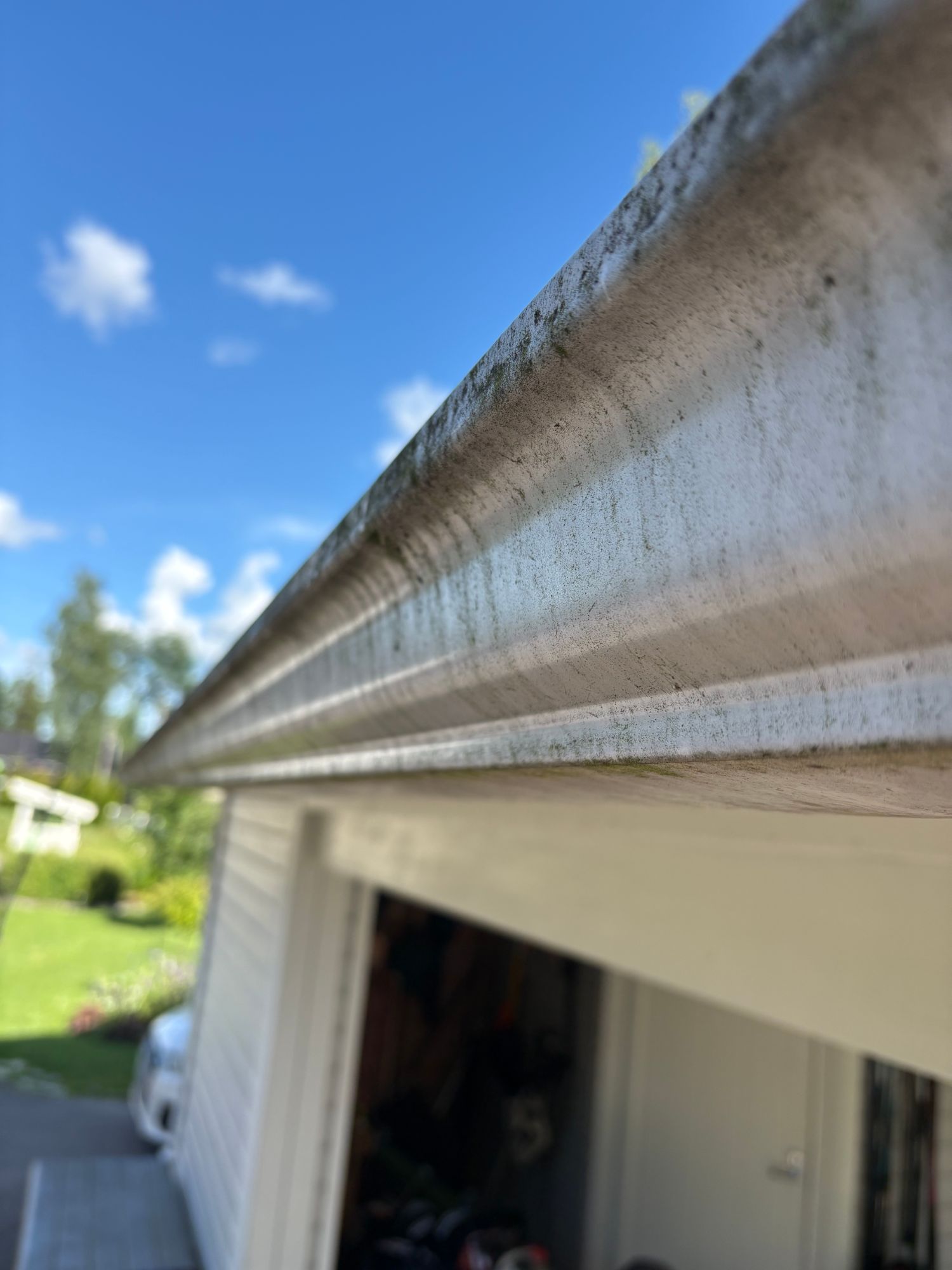 Gutter before the wash — dark streaks and ground-in grime