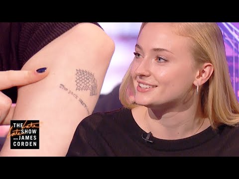 Sophie Turner displaying the direwolf-and-script tattoo on her left rear forearm during The Late Late Show