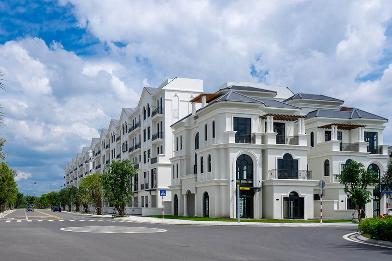 A white building with trees and a street
AI-generated content may be incorrect.