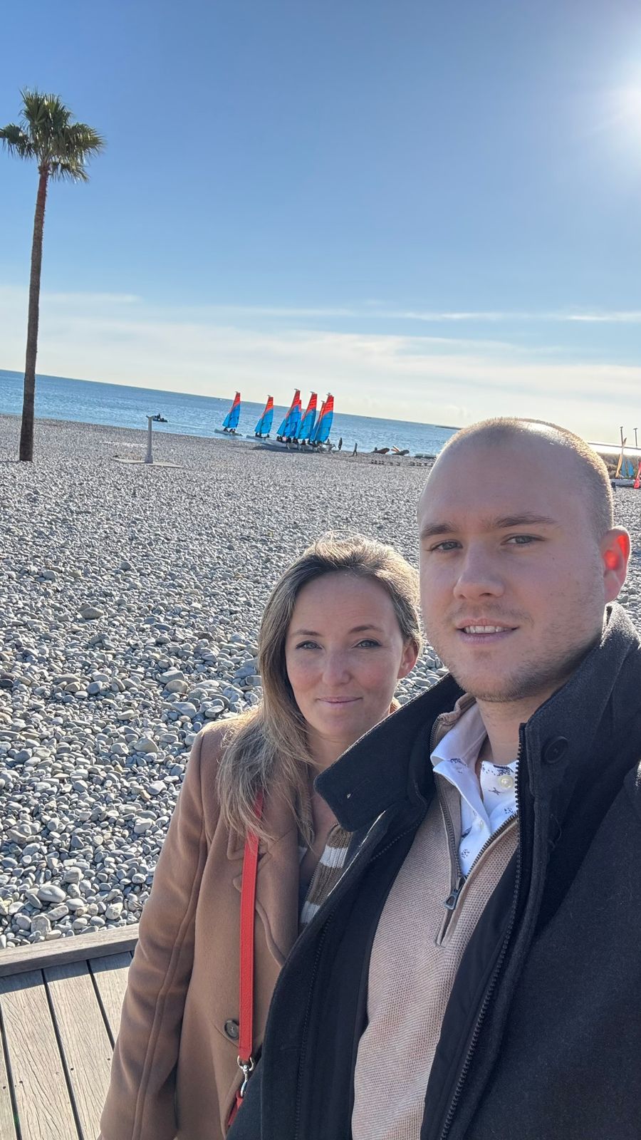 Adrien and Emily on a pebble beach