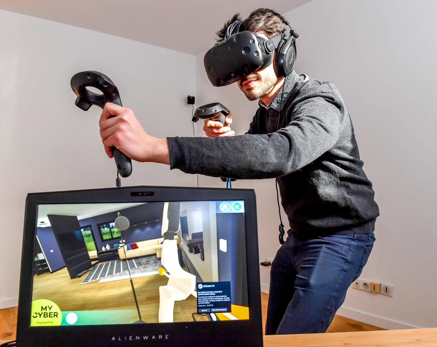 User wearing a VR headset and controllers interacting with a virtual room on SteamVR