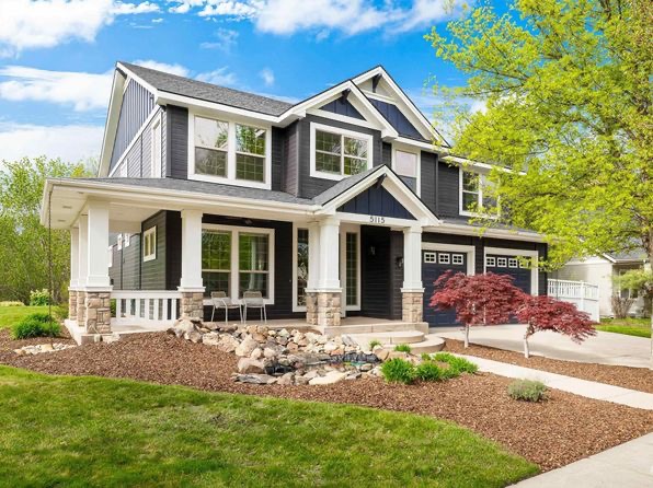 A beautiful modern two-story house with a well-manicured lawn