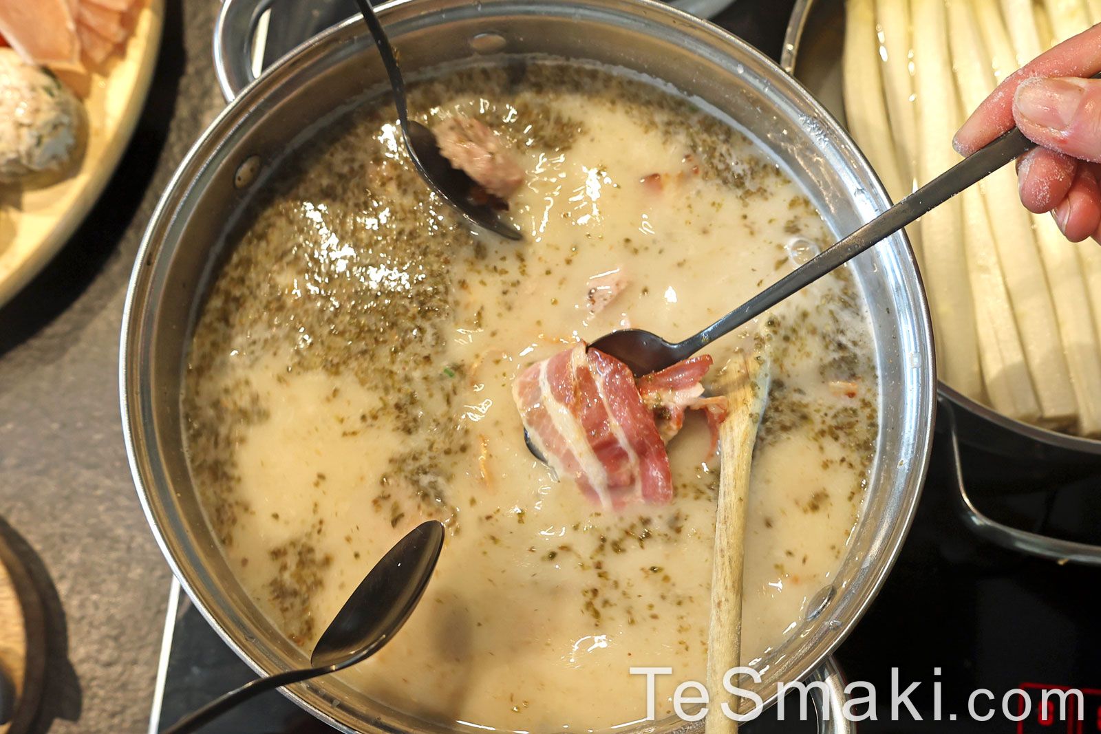 Traditional Polish Sour Rye Soup in Bread with White Sausage and Bacon