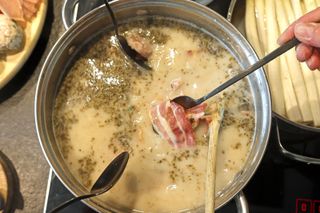 Traditional Polish Sour Rye Soup in Bread with White Sausage and Bacon