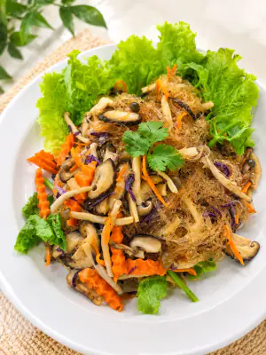 Stir-fried glass noodles with shiitake mushrooms and mixed vegetables.
